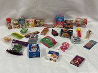 Full group shot of the 24 Mini Brands items spread on white backdrop
