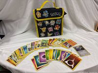 Front of lunch bag with Pokémon characters and spread of trading cards