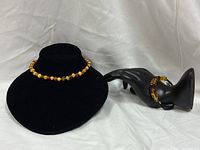 Necklace on bust form and bracelet on hand form