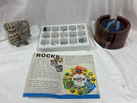 Group shot of rock identifier kit, booklet, carved elephant, and agate coasters in holder
