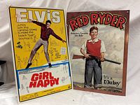 Both metal signs side by side: Elvis Girl Happy and Red Ryder Daisy