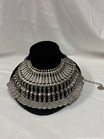 Front view of full bib necklace on display bust