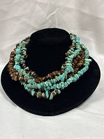 Full view of multi-strand chip bead necklace on display bust