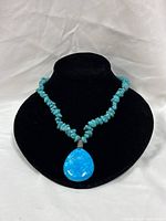 Full view of turquoise chip bead necklace displayed on bust