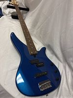 Full view of Yamaha metallic blue bass guitar body, neck and headstock
