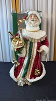 Front view of Santa tree topper with accessories and box visible