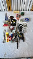 Overall view of assorted tools, testers, blades, gauge, small hardware