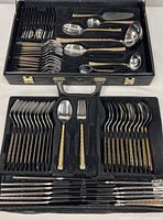 Full set in open case displaying two trays of flatware and serving pieces