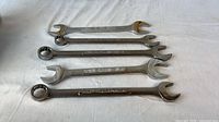 Five Craftsman combination wrenches laid flat showing both ends
