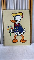 Full view of framed Donald Duck embroidery