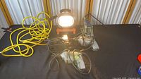 All five items grouped: two drills, jigsaw, HDX work light with yellow cord, scissor jack