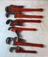 Six Ridgid pipe wrenches arranged by size
