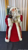 Front view of Santa tree topper showing robe, beard, miniature tree and staff
