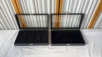 Both glass-top cases open, showing interiors