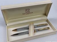 Set in open box showing pen and pencil