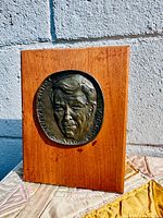 Front view of oak plaque with bronze medallion