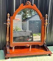 Front view showing full mirror, frame, and base