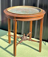 Full view of walnut table with brass top