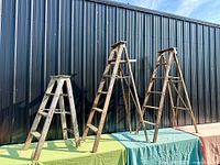 All three wooden stepladders side by side