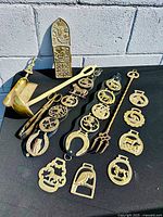 Group shot of all brass items on black surface