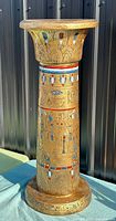 Full view of Egyptian style pedestal column showing hieroglyphic decoration and lotus capital
