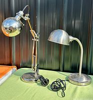Both chrome desk lamps standing side by side showing overall design and cords