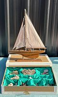 overall view of sailboat model and open box of beach items