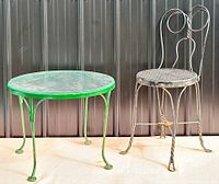 Overall view of green round table and black parlour chair