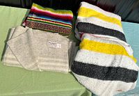 Four folded wool blankets laid out on table