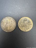 Both temple tokens obverse sides shown for design and inscription detail