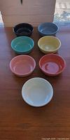 All seven bowls displayed upright showing interiors and colors