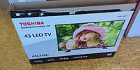 Front of Toshiba 43L310U TV box showing branding and product image