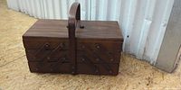 Closed wooden accordion sewing box front view