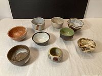 Nine of the ten assorted studio pottery bowls displayed together