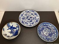 All three porcelain dishes top view showing designs and relative sizes