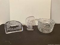 Three Swedish art glass pieces: bowl, elk plaque, couple plaque