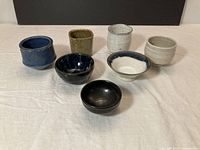 Group shot of all seven ceramic tea bowls and cups