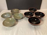 Group of eight bowls, four green and four black