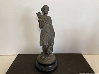 Full view of fisherwoman statue on base