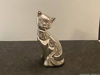 Front view of silver clad cat figurine