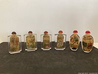 All six reverse painted snuff bottles lined up