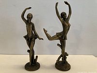 Two bronze ballerina statues front view
