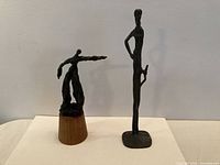 Both bronze statues side by side