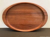 Front view of oval teak tray showing overall shape and rim