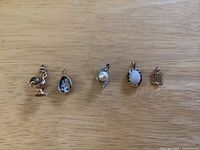 Five pendants laid out in order