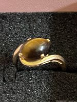 Top angle of 14k gold tiger eye ring in foam insert