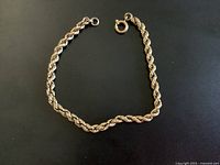 Full view of rope chain bracelet laid flat