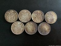 Seven coins reverse side; six Coat of Arms, one wolf