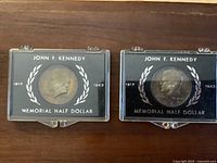 Front view of both memorial half dollars in holders