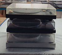 Stacked view showing all three Yamaha turntables with dust covers closed